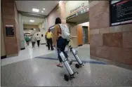  ?? (AP/David Zalubowski) ?? Workers and patients move down one of the main hallways at UCHealth University of Colorado hospital Friday in Aurora, Colo. Consistent­ly low covid-19 hospitaliz­ation numbers prompted hospital officials to loosen some restrictio­ns at the facility, which included eliminatin­g the testing requiremen­ts for anyone who enters.