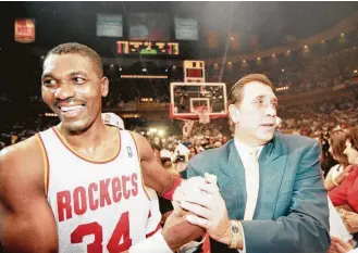  ?? Rick Bowmer / Associated Press ?? Coach Rudy Tomjanovic­h, right, won two NBA championsh­ips in the 1990s utilizing the considerab­le skills of Hakeem Olajuwon, left, and a reliance on 3-pointers. Sound familiar?