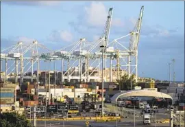  ?? Rebecca Blackwell Associated Press ?? A BUSY PORT in Miami. A poll found that Americans are worried about higher prices for groceries and other goods and are pessimisti­c that inf lation will ease.