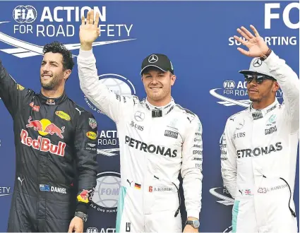  ??  ?? Pole man Nico Rosberg is joined by team-mate Lewis Hamilton (right) and Daniel Ricciardo yesterday, after the German had celebrated his stunning lap at Hockenheim (below).