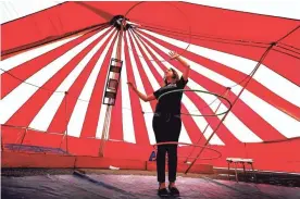  ??  ?? Circus performer Leslie Luna practices her hula hoop act under the “Big Top” tent while preparing for the Mid-South Fair at the Landers Center in Southaven. The fair, which features carnival rides and food, runs through Sept. 30.