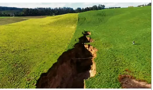  ??  ?? Human for scale: This TV screengrab from a TVNZ video shows the sinkhole that appeared on a dairy farm near Rotorua on New Zealand’s North Island. — AFP