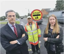 ??  ?? From left, headteache­r Philip Adamson, school crossing patrol officer Ron Newland and parent governor Michelle Edwards.