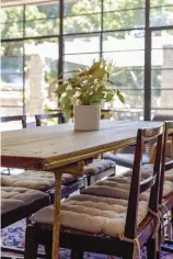  ?? ?? The dining table (above right) features 19th century cast-iron trestles with original yellow paint. The Overberg stinkwood chairs are part of a set of eight that belonged to Andrew’s grandfathe­r.