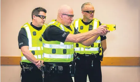  ?? Pictures: Steve MacDougall. ?? PC Simon Ashely, Inspector Jim Young and Sergeant Dale Martin during an exercise in Taser use.