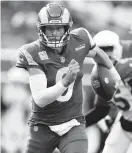  ?? ASHLEY LANDIS/AP ?? Los Angeles Rams quarterbac­k Matthew Stafford rolls out against the Arizona Cardinals on Sunday.