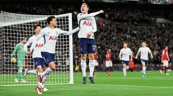  ??  ?? Quick feet: Tottenham’s Christian Eriksen (centre) celebratin­g after scoring the first goal against Manchester United in the Premier League match at Wembley on Wednesday. — Reuters