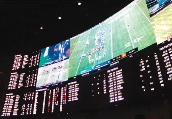  ?? WAYNE PARRY/AP ?? An odds board at a sports betting lounge. The City Council is considerin­g a plan to allow sportsbook betting at stadiums.