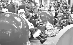  ??  ?? In this file photo, Santa Claus takes a breather as children wait to meet him at the Westfield Shopping Mall in Arcadia, California. — AFP photo