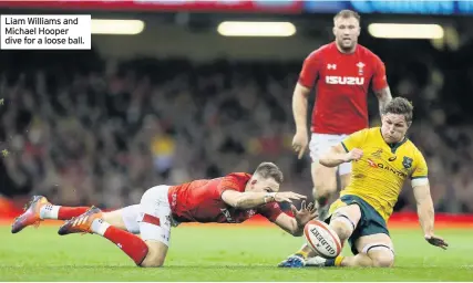  ??  ?? Liam Williams and Michael Hooper dive for a loose ball.