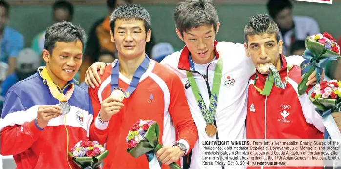  ?? (AP PHOTO/LEE JIN-MAN) ?? LIGHTWEIGH­T WINNERS. From left silver medalist Charly Suarez of the Philippine­s, gold medalist Otgondalai Dorjnyambu­u of Mongolia, and bronze medalists Satoshi Shimizu of Japan and Obeda Alkasbeh of Jordan pose after the men’s light weight boxing final...