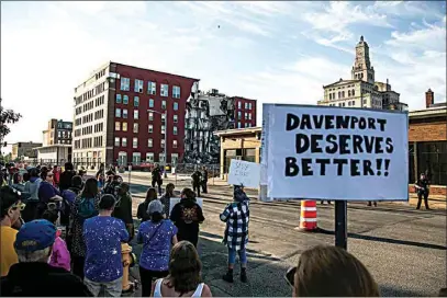  ?? JOSEPH CRESS / IOWA CITY PRESS-CITIZEN ?? Davenport police officers on Tuesday form a line opposite protesters that are advocating for search efforts to continue near the site of an apartment building that partially collapsed in Davenport, Iowa.