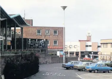  ??  ?? Looking across the car park below Birdcage Walk, towards Rumbelows, you can just make out the little kiosk in the centre of the image. Stanton’s Music Shop originally occupied the Rumbelows building.you can just see some of the bus shelters on the right, part of the Fisher Street bus terminus, and the Angel pub behind them at far right