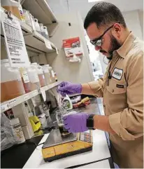  ?? Elizabeth Conley / Houston Chronicle ?? Chemical technician Victor Guajardo makes a blend in the labs at Huntsman Corp. in The Woodlands.