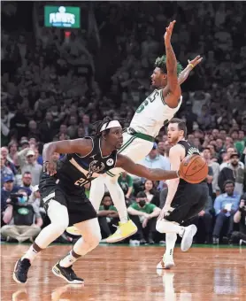  ?? DAVID BUTLER II/USA TODAY SPORTS ?? Bucks guard Jrue Holiday steals the ball from Celtics guard Marcus Smart in the final seconds to seal Milwaukee’s Game 5 victory.