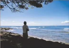  ?? AP file photo/Mengshin Lin ?? Abraham “Snake” Ah Hee, one of the first crew members of Hokulea —the Polynesian double-hulled voyaging canoe, looks at the ocean at Launipoko Beach Park on Feb. 23 in Lahaina. Hawaii authoritie­s said Thursday that coastal waters off the wildfire-stricken town of Lahaina pose no significan­t risk to human health and it’s safe to surf and swim there.