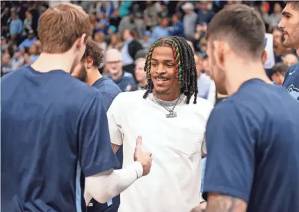  ?? CHRIS DAY/THE COMMERCIAL APPEAL ?? Grizzlies’ Ja Morant (12) high fives his teammates prior to the game between the Memphis Grizzlies and the Dallas Mavericks at Fedexforum in Memphis, Tenn., on March 20, 2023.