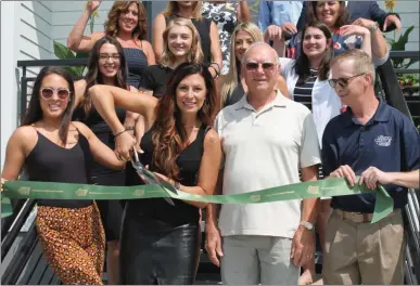  ?? LAUREN HALLIGAN - MEDIANEWS GROUP ?? Business owner Ann-Marie Flores cuts the ribbon during a ceremony to mark the grand opening of Crown Salon.