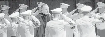  ?? Brett Coomer / Staff photograph­er ?? Former President George H.W. Bush is saluted as he arrives at the inaugural winter commenceme­nt convocatio­n at Texas A&amp;M University on Dec. 12, 2008, in College Station.