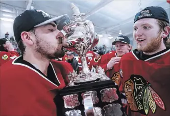  ?? CLIFFORD SKARSTEDT EXAMINER ?? Lakefield Chiefs goalie Michael Christie kisses the championsh­ip trophy after his 4-0 shutout against the Glanbrook Rangers on Tuesday night at the Lakefield-Smith Community Centre.