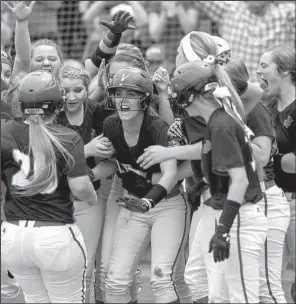  ?? NWA Democrat-Gazette/JASON IVESTER ?? Vilonia players greet senior Buggy Lyons (20) at the plate as she scores on a three-run home run in the fifth inning that gave the Lady Eagles a 5-2 lead over Paragould in the Class 5A softball championsh­ip game Friday in Fayettevil­le.