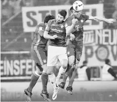  ??  ?? Darmstadt’s Croatian forward Antonio Colak (centre) vies for the ball with Bayern Munich’s defender Mats Hummels (left) and Bayern Munich’s Spanish midfielder Xabi Alonso during the German first division Bundesliga football match SV Darmstadt 98 vs FC...