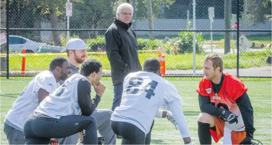  ?? RIC ERNST/ POSTMEDIA ?? B.C. Lions general manager Wally Buono looks over a group of players at practice last month. With the Lions sporting a 4-8 record, many feel Buono should be fired,