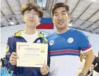  ?? ?? Clyd Guinto, left, holds his Certificat­e of Award from the Philippine Fencing Associatio­n (PFA) with his coach Ramil Endriano at the Fencing Hall of the PhilSports Complex in Pasig City.