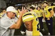  ?? Daniel Varnado / Associated Press ?? Georgia Tech interim head coach Brent Key celebrates with defensive back Clayton Powell-Lee after defeating Duke 23-20 in overtime Saturday at Bobby Dodd Stadium, in Atlanta.