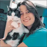  ?? Emil Koseoglu ?? Romoser and her cat, Phoenix, both tested positive for COVID-19. Romoser, who works in a Texas A&M lab, tested positive in March and again in September.