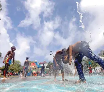  ?? — Reuters ?? Boys play at water fountains during the ‘World Children’s Day’ celebratio­ns in Colombo.