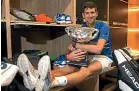  ??  ?? Novak Djokovic holds his Australian Open trophy.