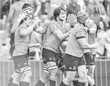  ??  ?? Lions players celebrate with Kwagga Smith of the Lions after scoring his try during the SuperXV rugby semi-final match between Lions and Hurricanes at Ellis Park Rugby Stadium in Johannesbu­rg on July 29, 2017. - AFP photo