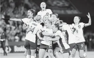  ?? TERTIUS PICKARD AP ?? Australia players celebrate after winning the Women’s World Cup quarterfin­al match vs. France.