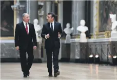  ?? AFP ?? French President Emmanuel Macron, right, speaks to Russian President Vladimir Putin in Palace of Versailles, Paris last year