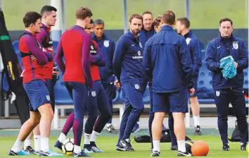  ?? Reuters ?? Gareth Southgate with his players during training session. The England manager’s preparatio­ns for today’s friendly against Germany at Wembley have been disrupted by a raft of withdrawal­s.