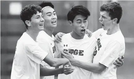  ?? DANIEL KUCIN JR./BALTIMORE SUN MEDIA GROUP ?? Marriotts Ridge’s Mark Lee, second from right, celebrates during the Mustangs’ soccer playoff victory over Centennial on Saturday.