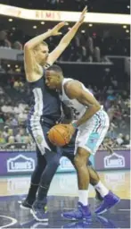  ?? Streeter Lecka, Getty Images ?? Nuggets center Nikola Jokic defends against the Charlotte Hornets’ Dwight Howard on Wednesday night.