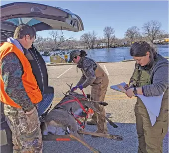  ?? DALE BOWMAN/SUN-TIMES ?? Clockwise from top left: Autumn Sellek, 10, watches intently as wildlife biologist Stefanie Fitzsimons samples a deer brought to a McHenry County check station on opening day of Illinois’ firearm deer season in November, 2019; Fitzsimons and Emma Trone check in a deer; and a check station sign.