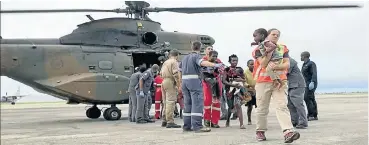  ?? Picture: IPSS Medical Rescue ?? Rescuer Ceron Meadows of Rescue Care with a child rescued from the Buzi district in Beira, Mozambique.