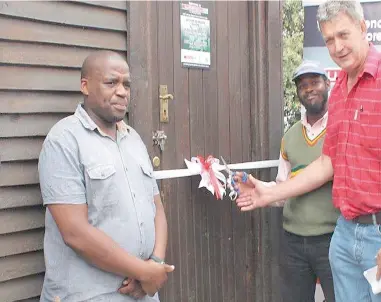  ??  ?? OFFICIAL OPENING: Khayelitsh­a SuperSpar general manager Kokkie Crous cuts the tape at the relaunch of the trauma room, while Khayelitsh­a Community Policing Forum spokesman Lungu Guza, left, looks on.