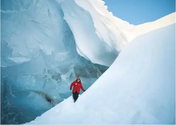  ?? (Reuters) ?? RUSSIAN PRESIDENT Vladimir Putin visits the cave of Arctic Pilots Glacier in Alexandra Land in the remote Arctic islands of Franz Josef Land last month.