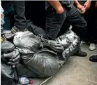  ?? AP ?? Protesters pull down a statue of slave trader Edward Colston during a Black Lives Matter protest rally in Bristol on June 7.