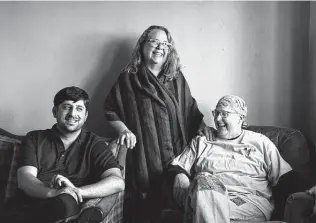  ?? David Goldman / Associated Press ?? Ihsanullah Patan, left, a horticultu­rist and Afghan refugee, talks with Caroline Clarin, right, with whom he worked in Afghanista­n, and her wife, Sheril Raymond, at his new Minnesota home.