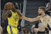  ?? JEFF CHIU — THE ASSOCIATED PRESS ?? Golden State Warriors forward Draymond Green is defended by Indiana Pacers forward Domantas Sabonis during the first half in San Francisco on Friday.