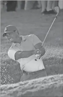  ?? Wilfredo Lee / AP ?? Tiger Woods hits out of a bunker on the 18th hole during the second round of the Honda Classic on Friday in Palm Beach Gardens, Fla.