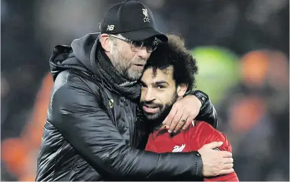  ?? Picture: Reuters ?? FEELING THE LOVE. Liverpool manager Jurgen Klopp hugs Mohamed Salah after their 1-0 win over Napoli in the Champions League at Anfield on Tuesday night.