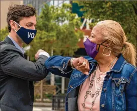  ?? ALYSSA POINTER/ ALYSSA. POINTER@ AJC. COM ?? Democrat JonOssoff, seeking aU. S. Senate seat, greets a supporter, Onita Howard of Clayton County, before speaking at a press conference near State Farm Arena on Thursday.