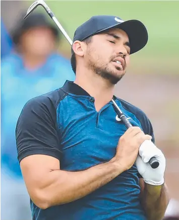  ?? Pictures: AAP ?? BIRDIE BLITZ: Jason Day (above) reacts to his second shot at the 17th hole yesterday before finishing with a three-under 68, closing in on tournament leader Lucas Herbert (below).