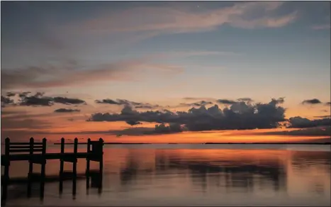  ?? Photos for The Washington Post by Roy Furchgott ?? Above, the sun sets outside the Bay Harbor Lodge in Key Largo, Fla. Below, pitcuresqu­e coral reef up close.